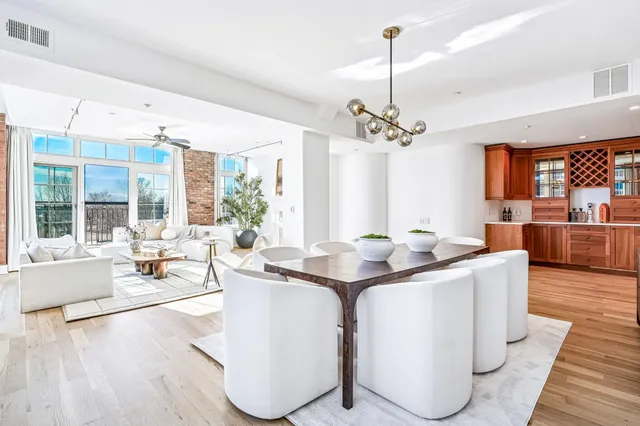 a living room with furniture a chandelier and a table