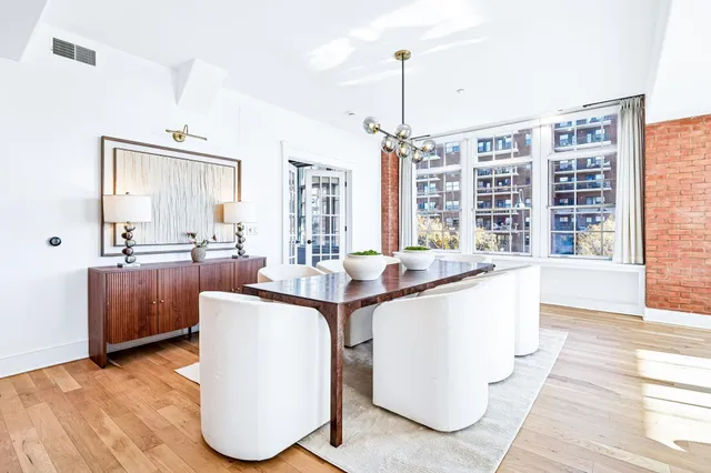 a living room with couches and cabinets with wooden floor