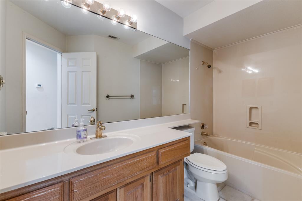 9939 Waterfront Trail Rowlett, TX 75087 - Photo 16 of 25 a bathroom with a sink a toilet and shower