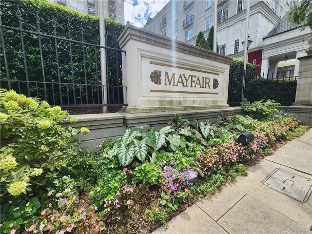 a sign broad in front of flowers