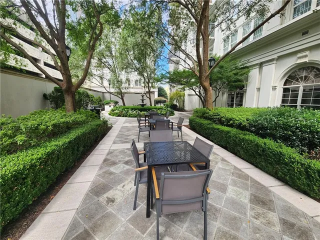 a view of a patio with table and chairs and potted plants