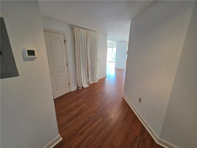 a view of a hallway with wooden floor