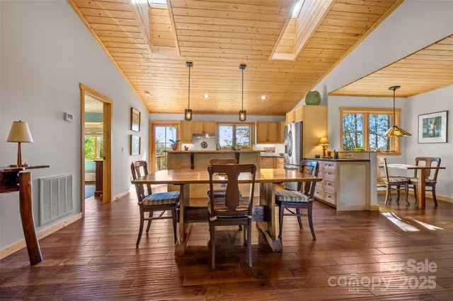 a dining room with furniture window and wooden floor