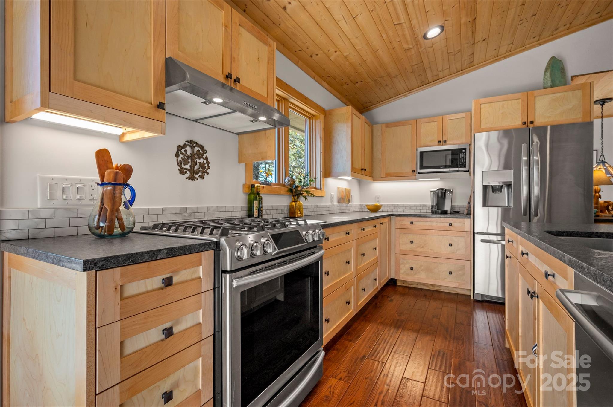 891 Meadow Crest Road Tryon, NC 28782 - Photo 16 of 47 a kitchen with stainless steel appliances granite countertop a stove a sink and a refrigerator