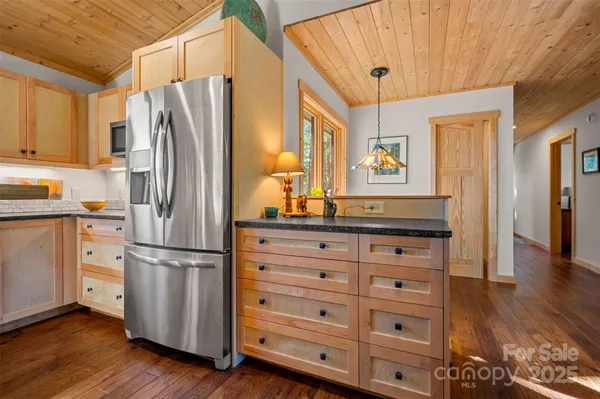 a kitchen with stainless steel appliances a refrigerator and a stove top oven
