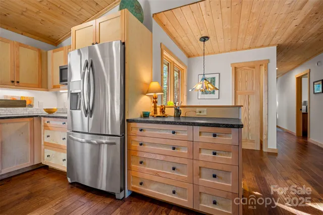 a kitchen with stainless steel appliances a refrigerator and a stove top oven