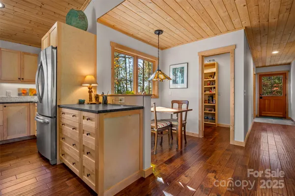 a kitchen with wooden floor and furniture