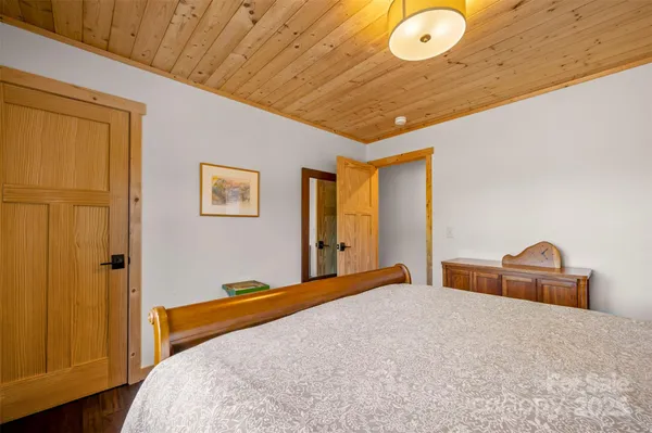 a bedroom with a bed and cabinets