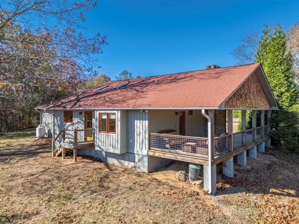 a view of a house with backyard porch and sitting area