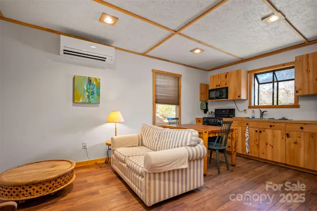 a kitchen with stainless steel appliances granite countertop a refrigerator a sink a stove a microwave and island