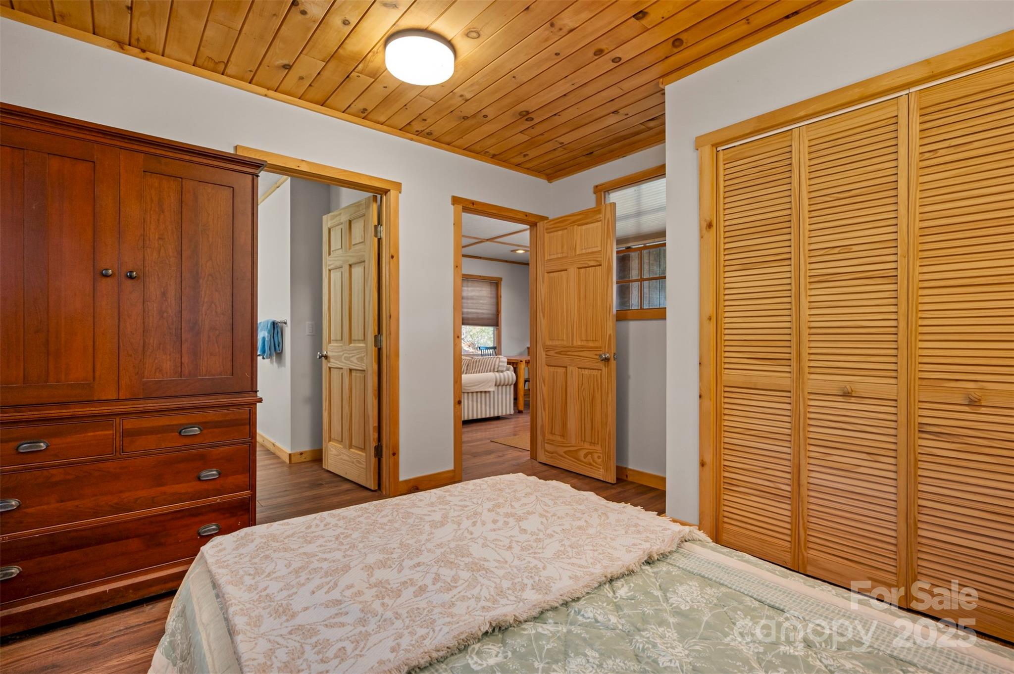 891 Meadow Crest Road Tryon, NC 28782 - Photo 37 of 47 a bedroom with a bed and wooden floor