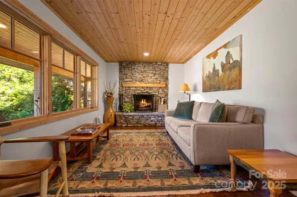 a living room with furniture a fireplace and a large window