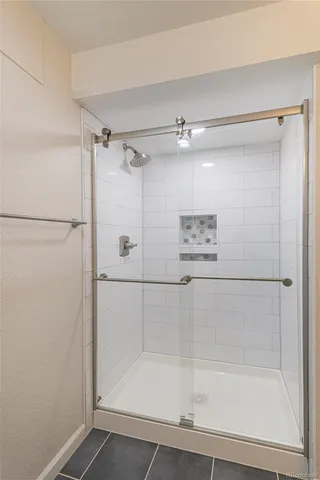 a bathroom with a shower and a glass door