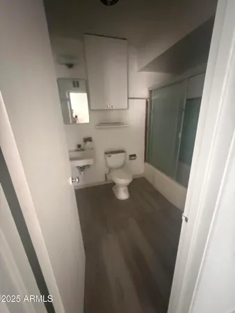 a bathroom with a toilet and a mirror
