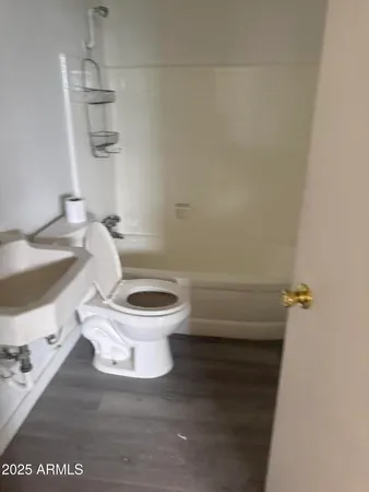 a white toilet sitting next to a bathroom sink