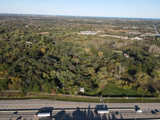 an aerial view of residential house with green space