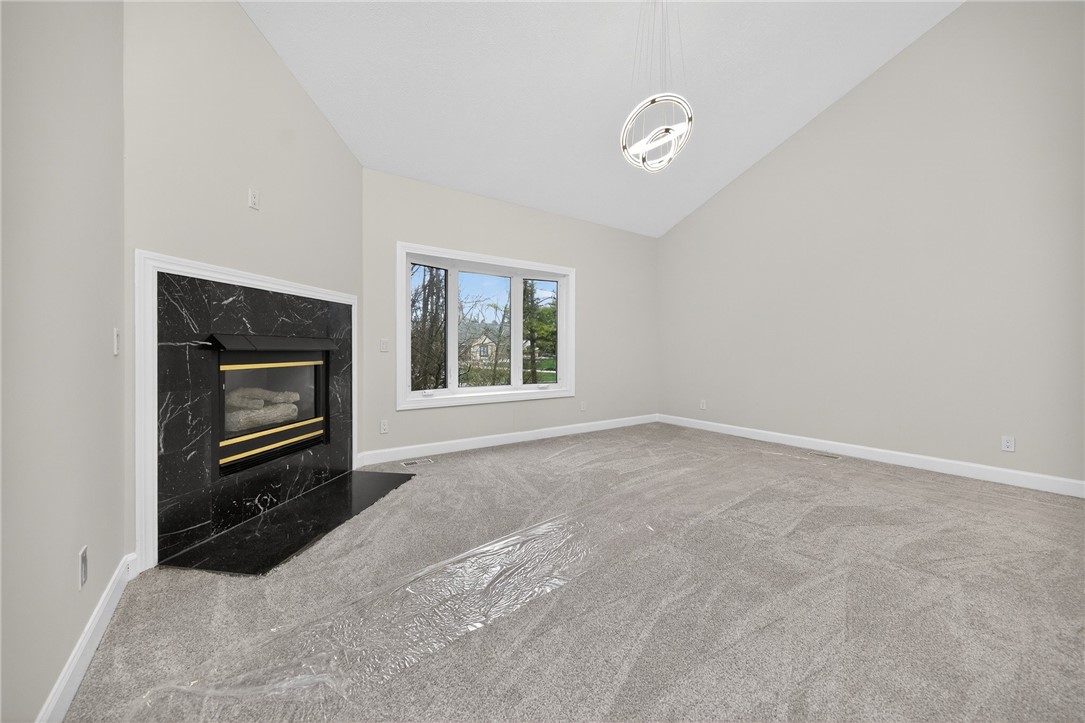 811 Wind Bluff Point Springboro, OH 45066 - Photo 16 of 51 This bright living space features a cozy fireplace, abundant natural light, and vaulted ceilings.