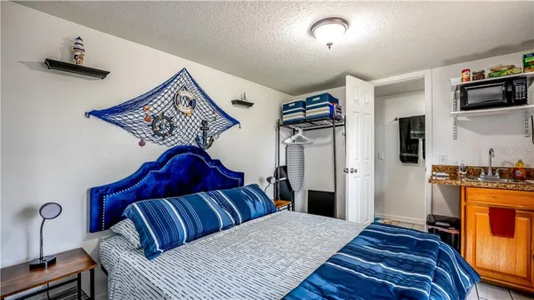 a bedroom with a bed and a television