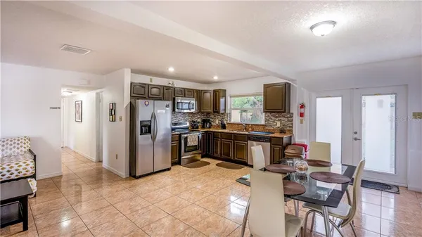a kitchen with stainless steel appliances a refrigerator and a stove top oven