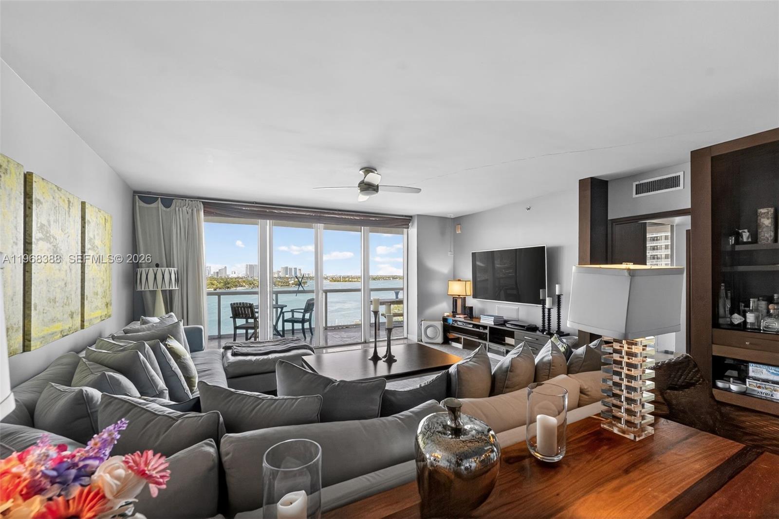 450 Alton Road, Unit 1202 Miami Beach, FL 33139 - Photo 2 of 15 a living room with furniture and a flat screen tv