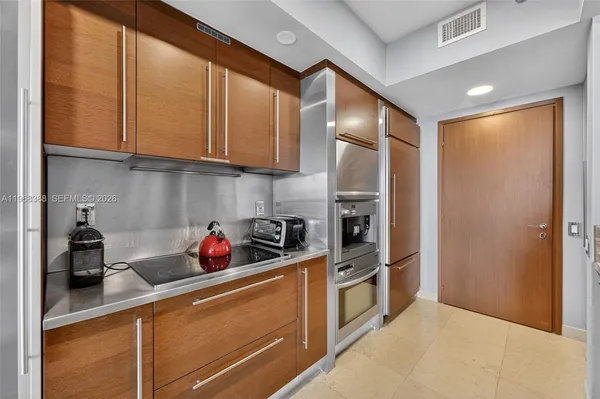 a kitchen with stainless steel appliances granite countertop a refrigerator and a sink