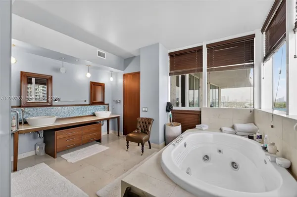 a large white room with a large window and furniture