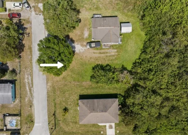 an aerial view of a house with a yard