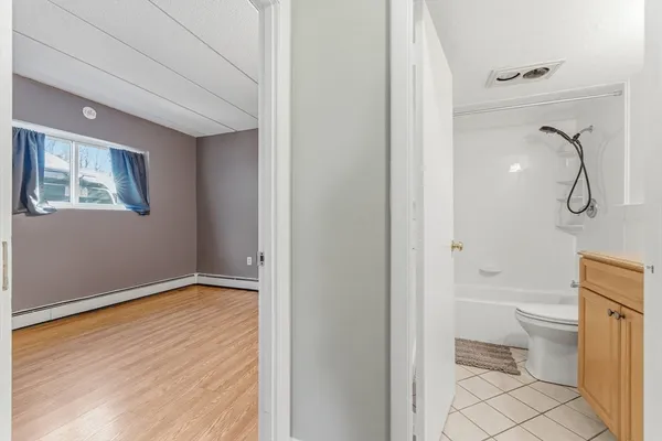 a bathroom with a granite countertop toilet and a shower