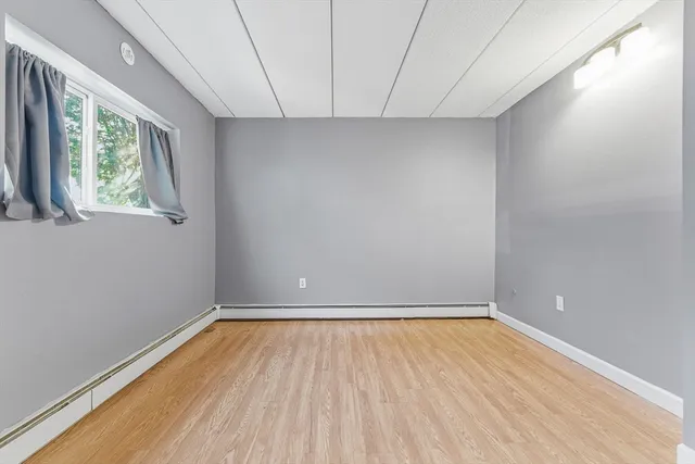 a view of room with window and hardwood floor
