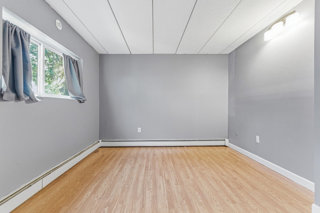 1011 Main Street, Unit 5 Woburn, MA 01801 - Photo 14 of 26 a view of room with window and hardwood floor