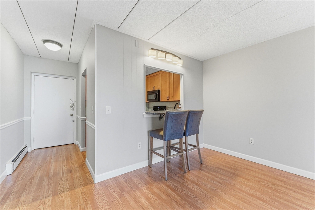 1011 Main Street, Unit 5 Woburn, MA 01801 - Photo 6 of 26 a view of a livingroom with furniture and wooden floor