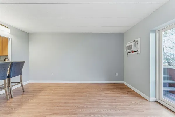 a view of room with window and wooden floor