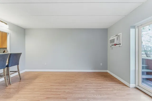 a view of room with window and wooden floor