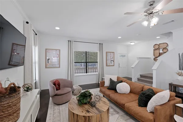 a living room with furniture and wooden floor