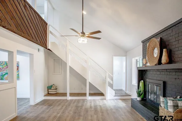 a view of entryway and hall with wooden floor