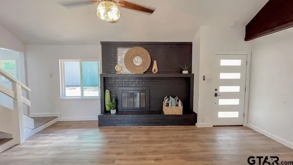 a living room with furniture and a fireplace
