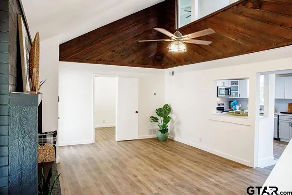 a workspace with wooden floor and ceiling fan