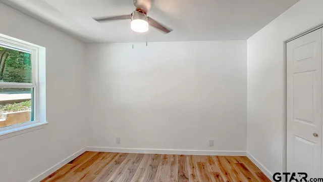 wooden floor in an empty room with a window
