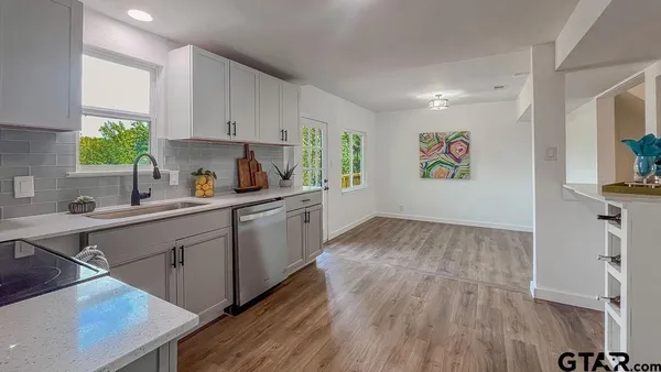 a kitchen with a refrigerator and a sink