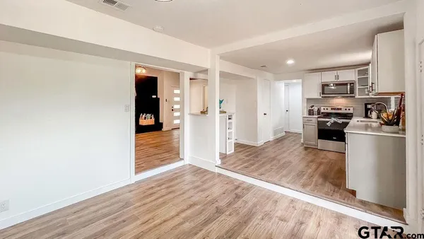 a kitchen with stainless steel appliances granite countertop a refrigerator and a stove top oven