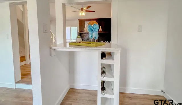 a view of living room with a mirror and a wooden floor
