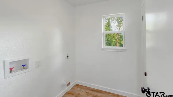 a view of a small space with window and closet