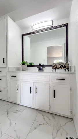 a view of white cabinets with sink and dishwasher