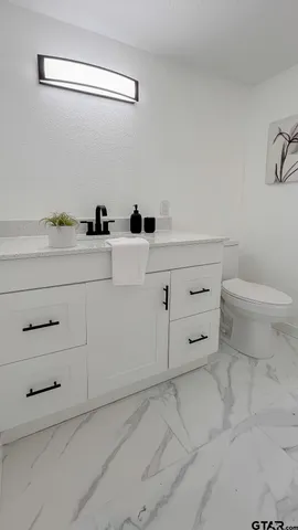 a bathroom with a toilet and a sink