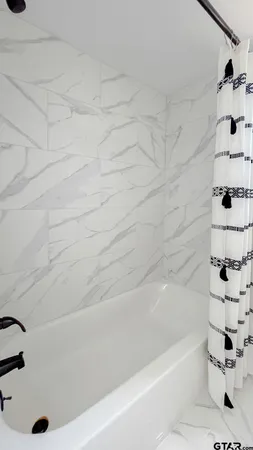 a bathroom with a bathtub and a shower