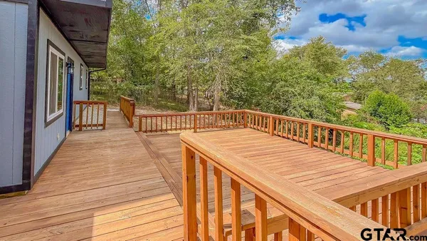 a view of a balcony with wooden floor