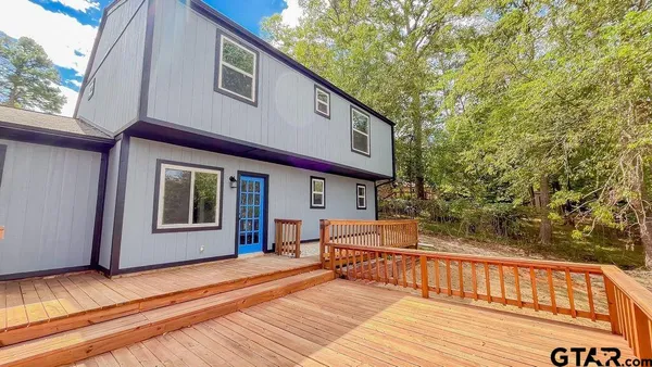 a view of a house with a balcony and furniture