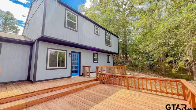 a view of a house with a balcony and furniture