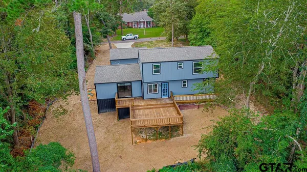 an aerial view of a house with a yard