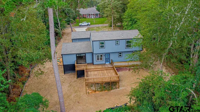 an aerial view of a house with a yard